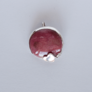 Pendant, rhodonite circle gem with small heart, bottom right