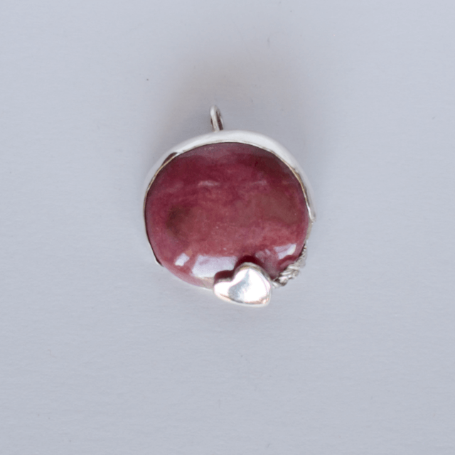 Pendant, rhodonite circle gem with small heart, bottom right