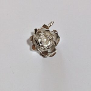 This dainty and lightweight rose is my creation, handmade, in sterling silver. I'm a gardener, and rarely cut roses for indoors, so a silver one is perfect, in my opinion: it is long lasting! This one is 1.2" high x 0.9" wide, and 0.4" deep, weighing just 0.2 ounces! BR201